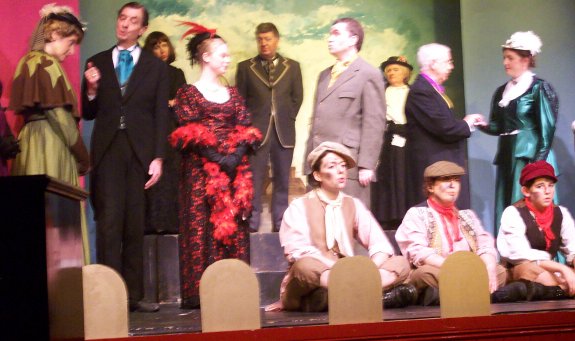 Back row: Gorgiano, Moriarty, Chorus. Main row: Mrs Hudson, Baron Gruner, Irene Adler, Sherlock Holmes, Dr Watson, Violet de Merville. Seated front: Noggins, Wiggins, Smuggins.
